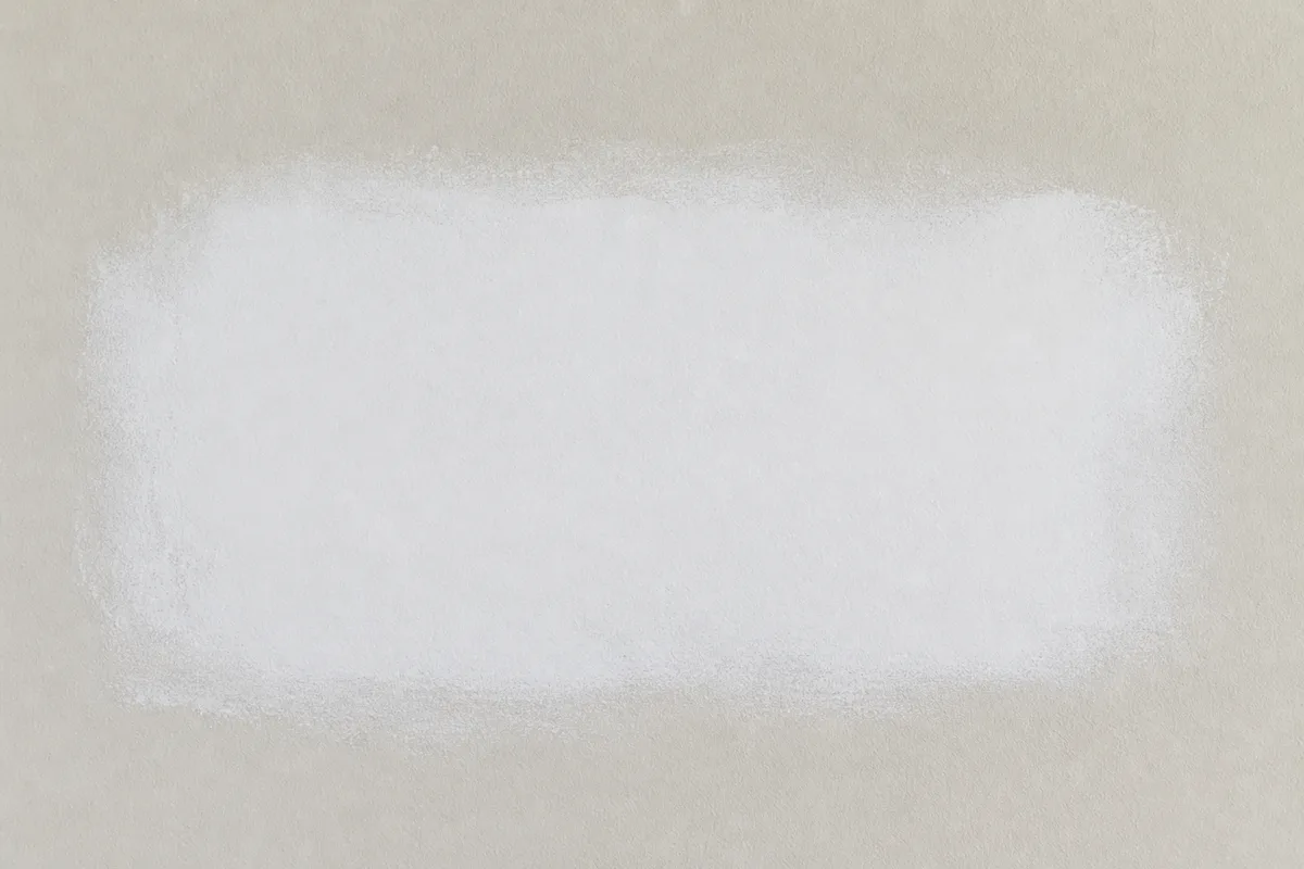 A primed and feathered drywall patch ready for painting